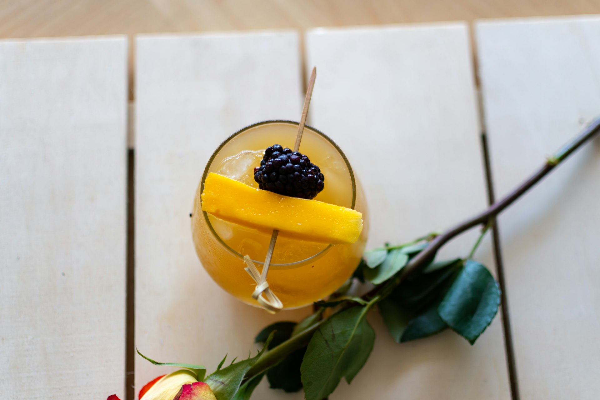 A helicopter view of a fruity cocktail on a table.
