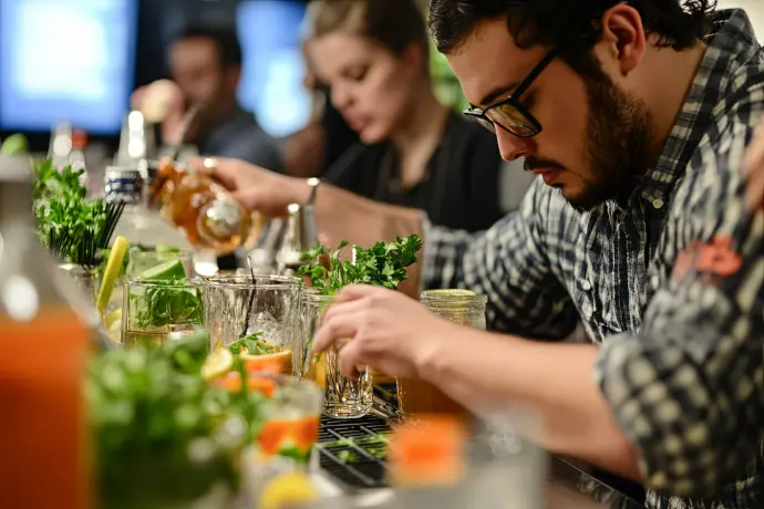 Participants preparing cocktails during a cocktail workshop